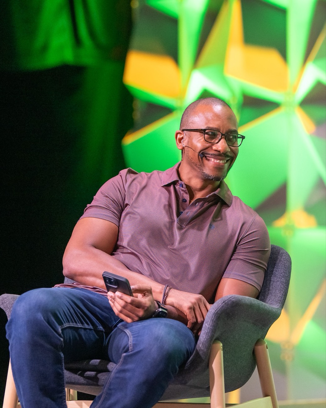 Johnny smiling, seated on stage during a GopherCon 2026 conversation
